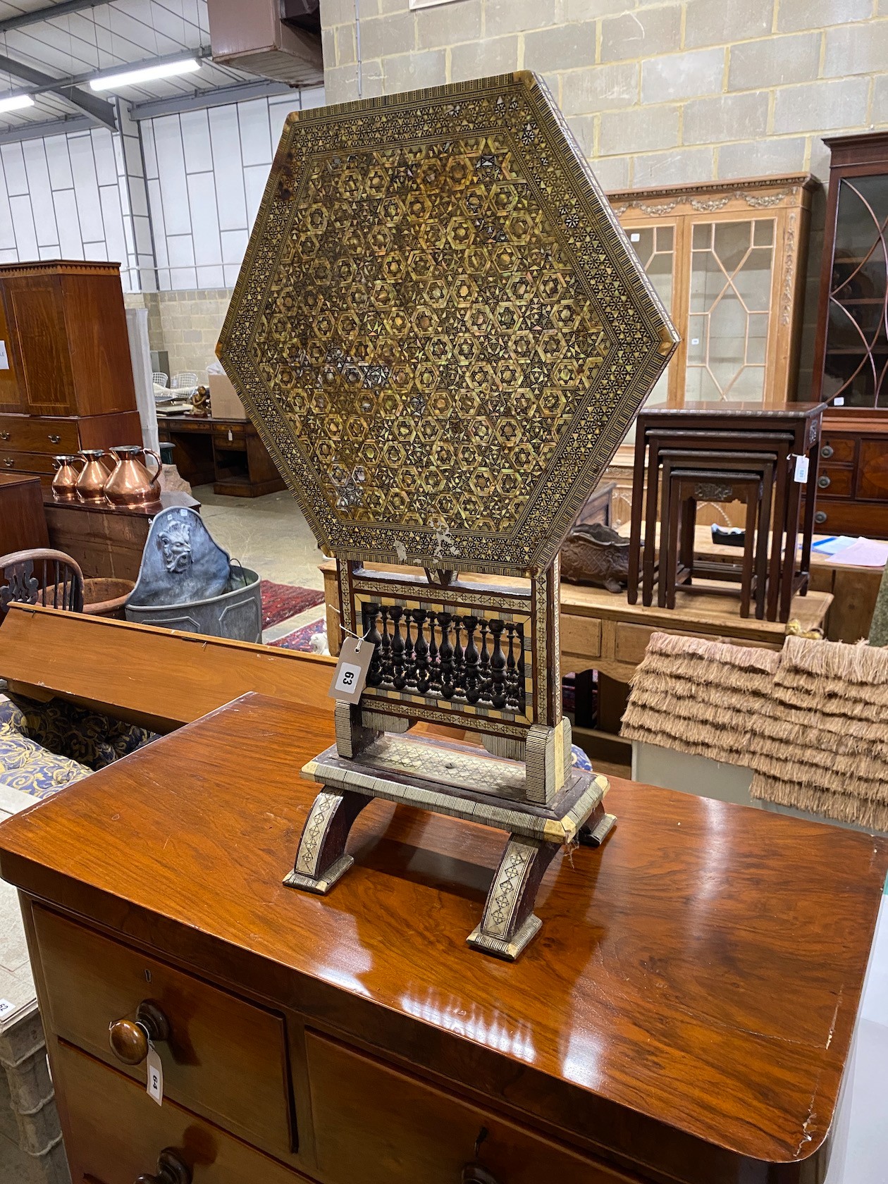 A Damascan hexagonal tilt top occasional table, width 50cm, height 61cm